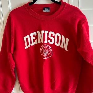 Denison University red sweatshirt size small.  Small dark stain shown in photo.